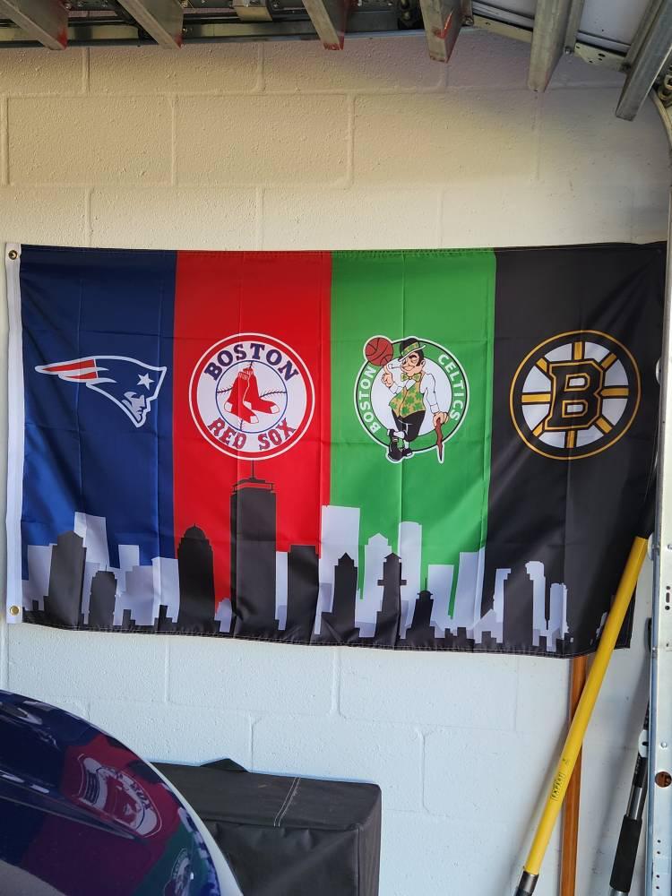 Customer photo of the Boston four-team skyline flag hanging on a wall