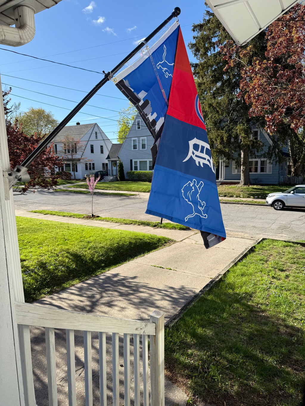 Customer photo of a custom Detroit team-combination flag flying outside