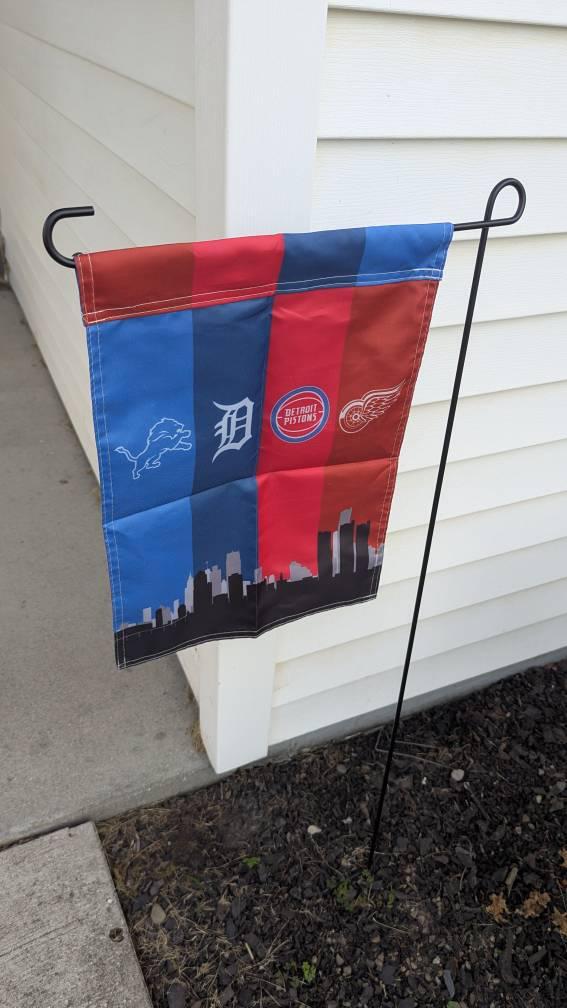 Customer photo of the Detroit four-team skyline garden flag on a pole sleeve stand