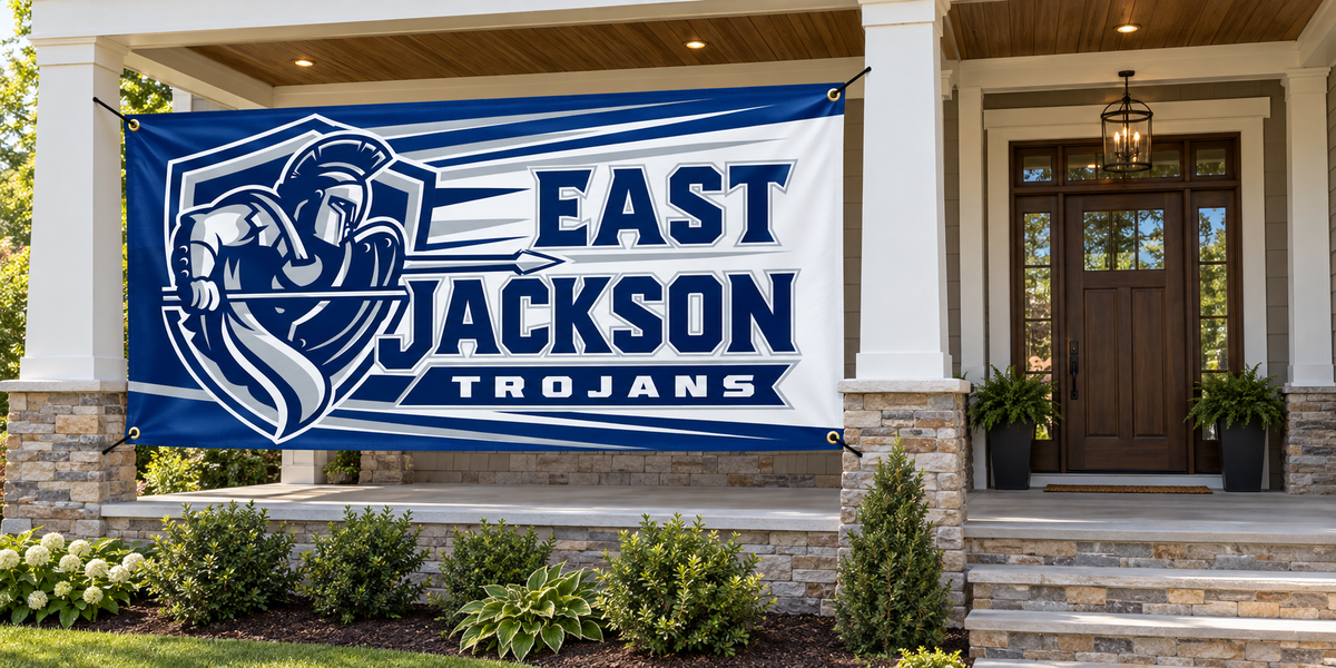 East Jackson Trojans 4 ft by 8 ft banner mockup with four corner grommets in side porch bay, leaving entrance clear