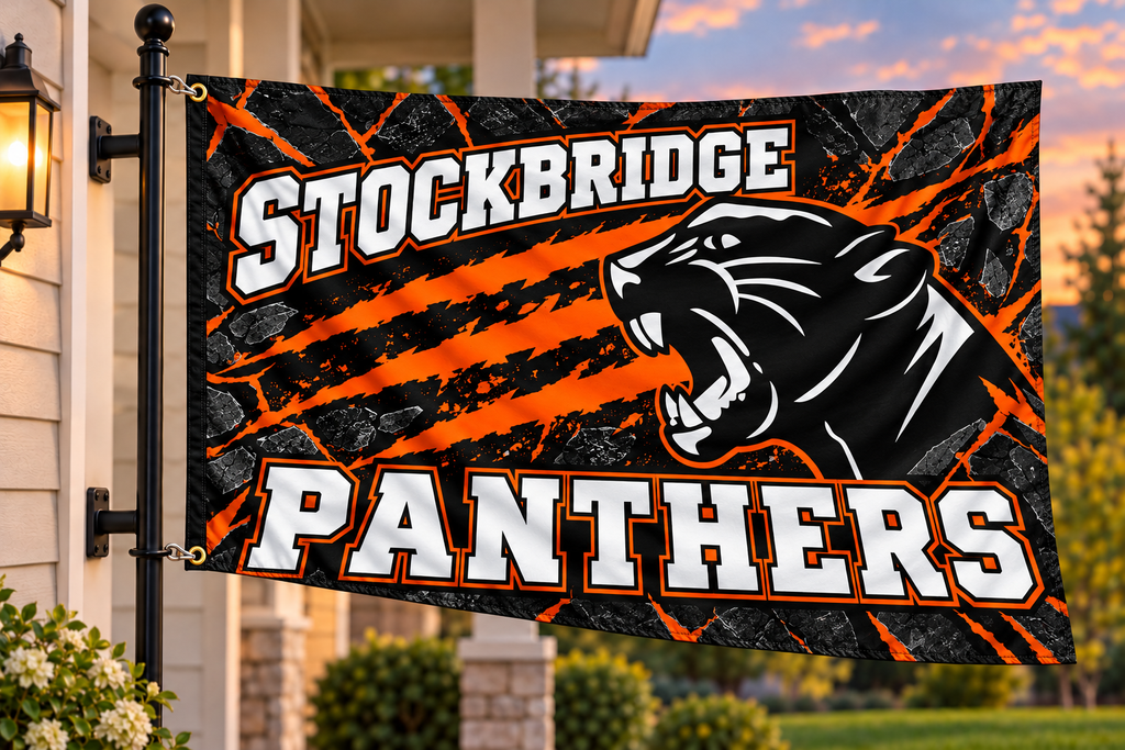Stockbridge Panthers flag with both left grommets clipped directly to the house-mounted pole