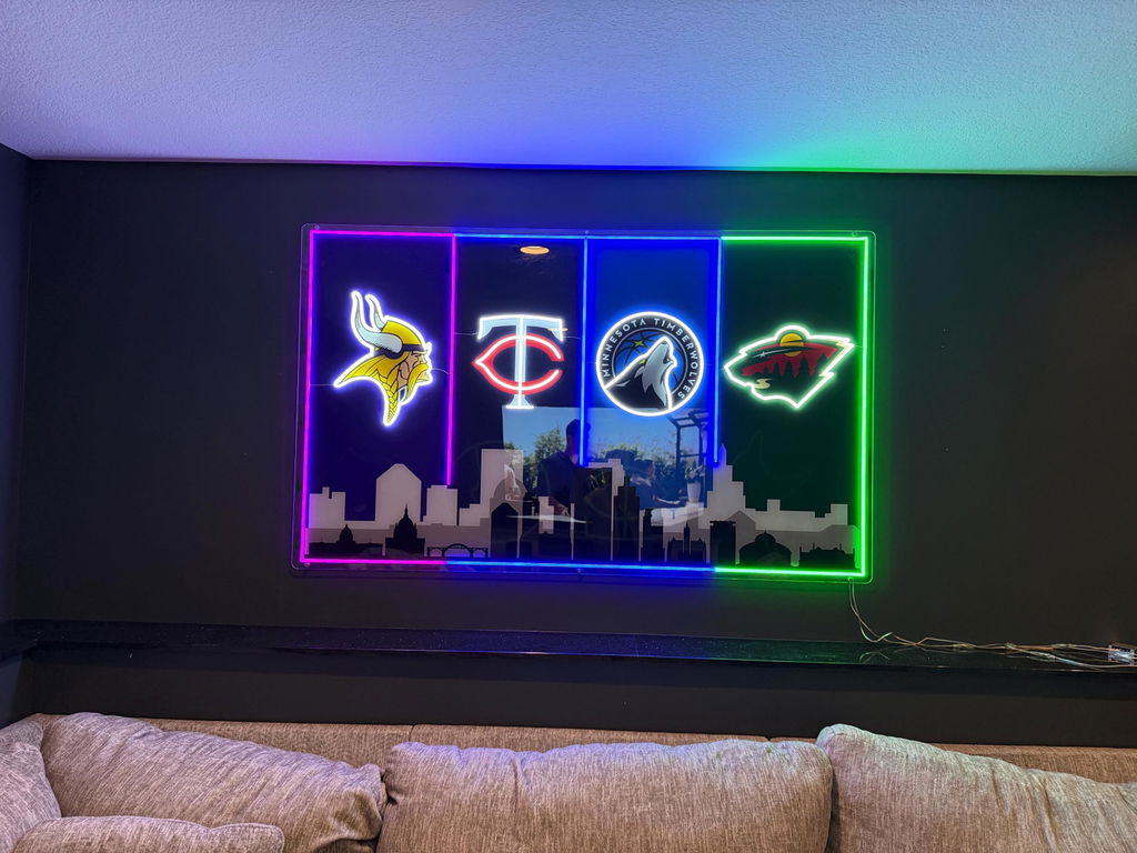Customer photo of the Minnesota four-team LED skyline sign installed above a sofa