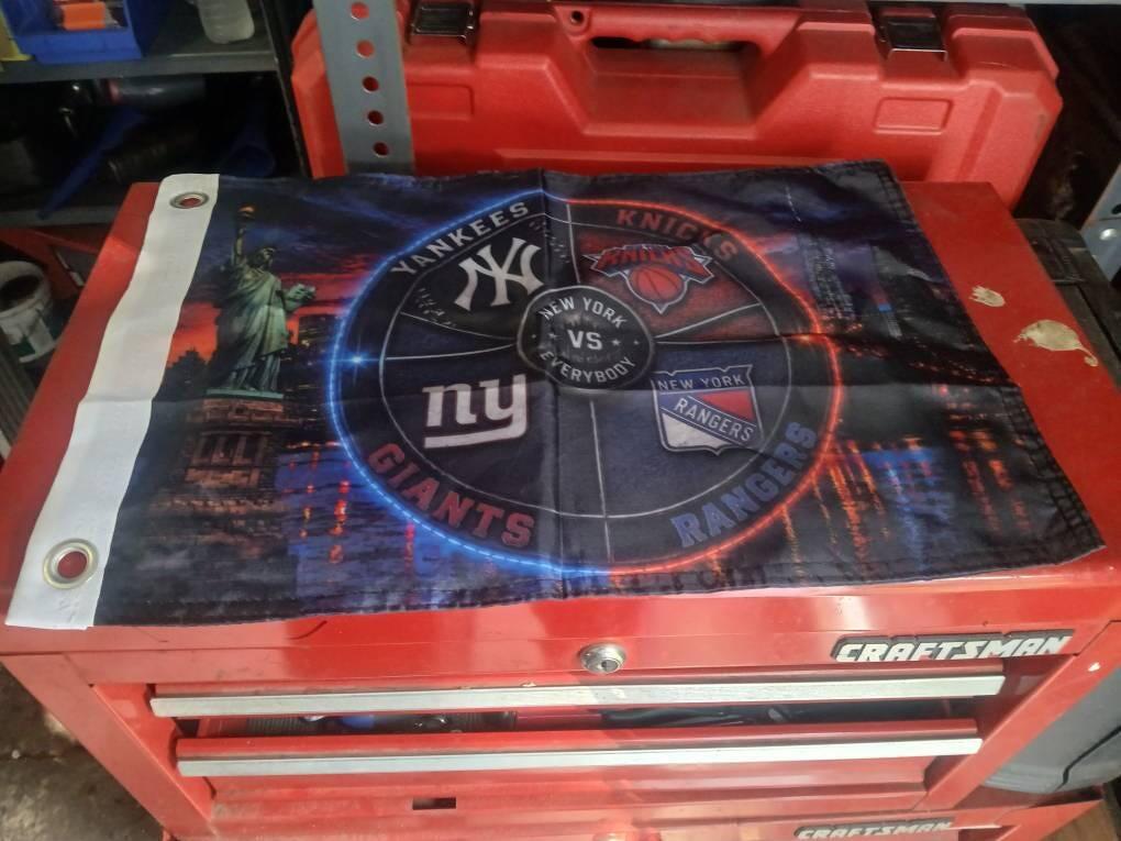 Customer photo of a New York vs Everybody sports flag with reinforced grommet edge