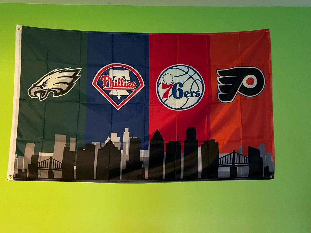 Customer photo of the Philadelphia four-team skyline flag on a green wall