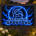 Springport Spartans Blue Glow printed flag displayed on a garden fence