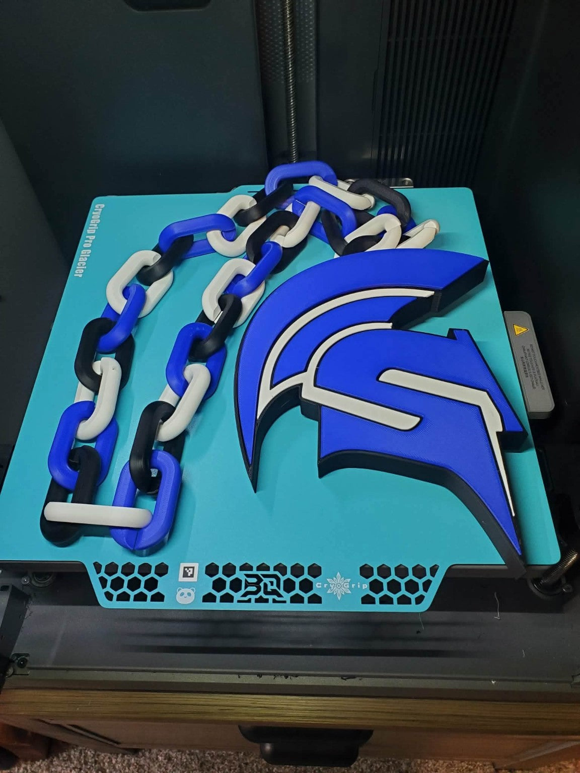 Actual Springport Spartans 3D-printed hype chain with blue helmet pendant and blue, white and black links.