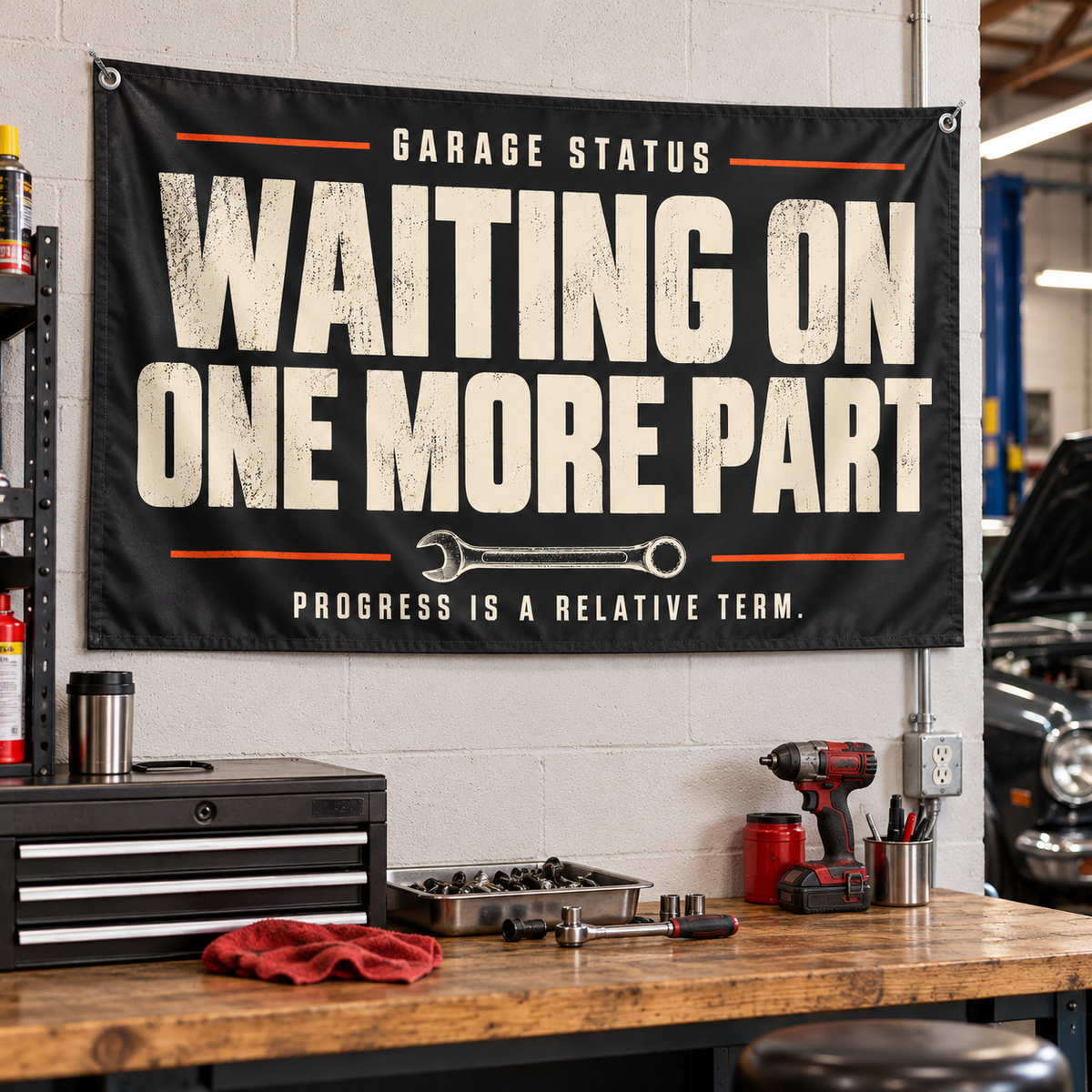 Waiting on One More Part Garage Flag shown hanging on a wall — realistic product mockup